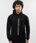 Model wearing Falcon black hoodie, close front view of vertical white lettering
