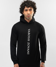 Model wearing Falcon black hoodie, close front view of vertical white lettering